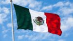 Flag of Mexico against blue sky background