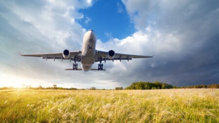 Aeroplan flying above field