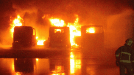 Image of vehicles on fire in yard