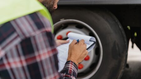 Vehicle driver checking tyre quality